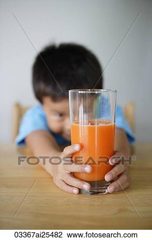 Little boy looking at glass of juice View Large Photo Image Stock Image - Little boy looking at glass of juice. Fotosearch