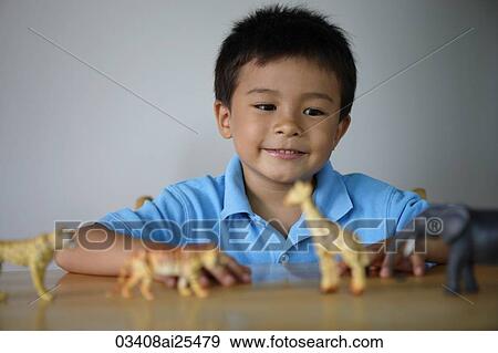Little boy playing with plastic animals View Large Photo Image Stock Photo - Little boy playing with plastic animals. Fotosearch