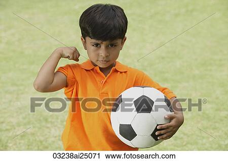 little boy showing muscle, holding soccer ball View Large Photo Image Stock Image - little boy showing muscle, holding soccer ball. Fotosearch
