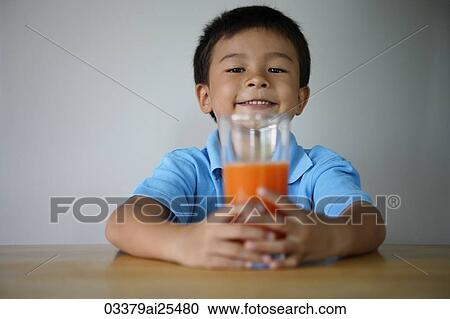 Little boy with glass of juice View Large Photo Image Stock Image - Little boy with glass of juice. Fotosearch