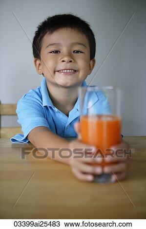 Stock Image - Little boy with glass of juice. Fotosearch