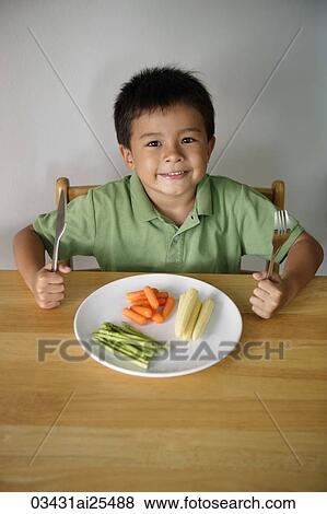 Little boy with plate of vegetables View Large Photo Image Stock Photo - Little boy with plate of vegetables. Fotosearch