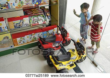 Stock Photo - Little boys staring in toy store window. Fotosearch