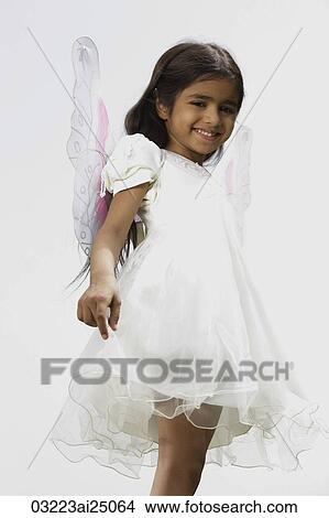Picture - little girl dressed in white dress and wings. Fotosearch