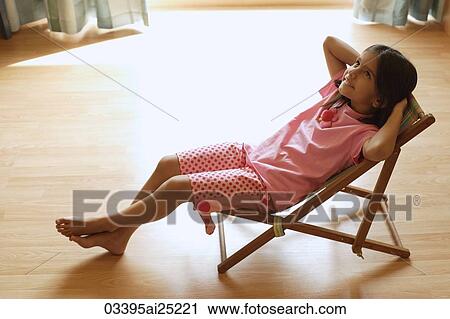Stock Image - Little girl in chair. Fotosearch