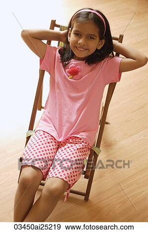 Little girl in chair View Large Photo Image Stock Photo - Little girl in chair. Fotosearch