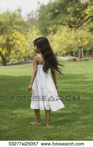 Little girl in park wearing white View Large Photo Image Stock Photo - Little girl in park wearing white. Fotosearch