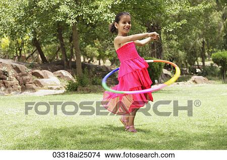 little girl playing with hula hoop View Large Photo Image Picture - little girl playing with hula hoop. Fotosearch