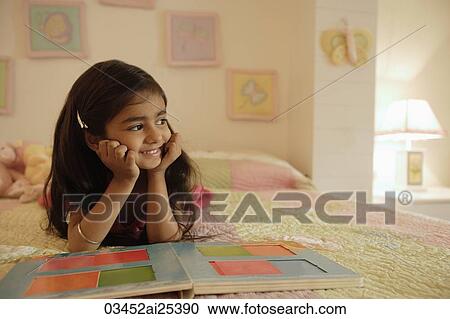 little girl reading book on bed View Large Photo Image Stock Image - little girl reading book on bed. Fotosearch