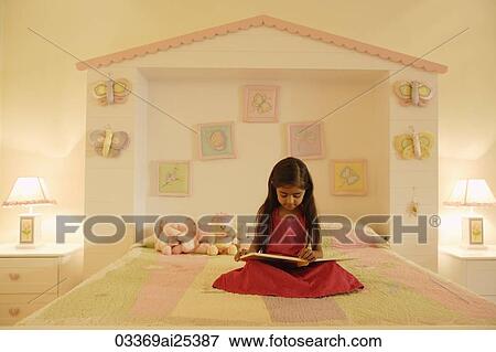 little girl reading book on bed View Large Photo Image Stock Photo - little girl reading book on bed. Fotosearch