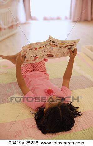 little girl reading on bed View Large Photo Image Stock Photo - little girl reading on bed. Fotosearch