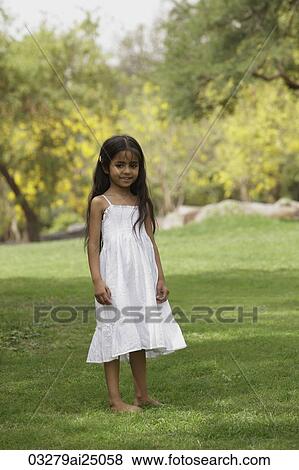 Little girl standing in park View Large Photo Image Stock Photo - Little girl standing in park. Fotosearch