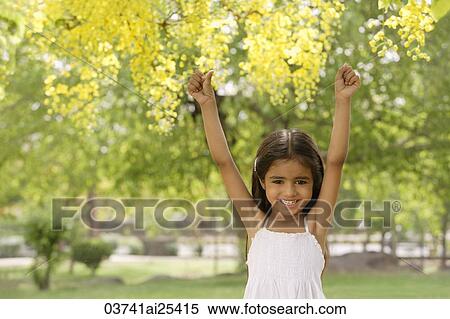 little girl standing under tree View Large Photo Image Stock Photography - little girl standing under tree. Fotosearch