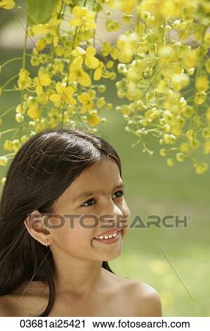 Stock Image - little girl under flowering tree. Fotosearch
