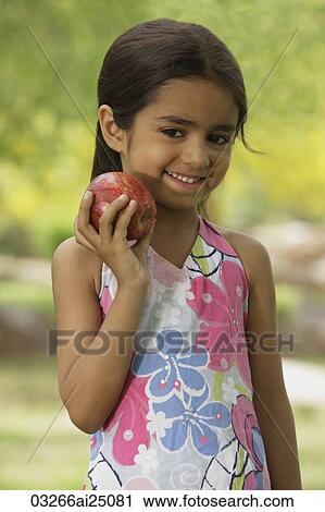 Stock Image - little girl with apple. Fotosearch