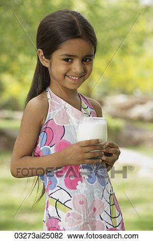 Stock Image - little girl with glass of milk. Fotosearch