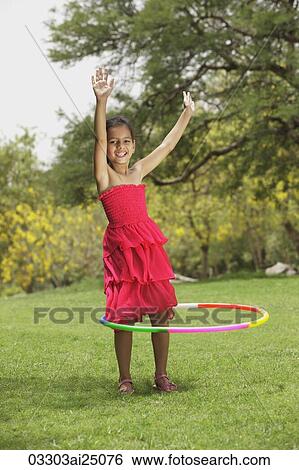 Stock Photograph - little girl with hula hoop. Fotosearch
