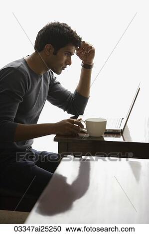 Stock Image - man at laptop. Fotosearch