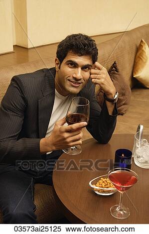 Man at table with glass of wine View Large Photo Image Stock Photography - Man at table with glass of wine. Fotosearch