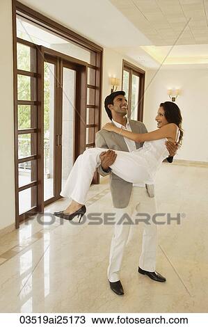 Man carrying woman over threshold View Large Photo Image Stock Image - Man carrying woman over threshold. Fotosearch