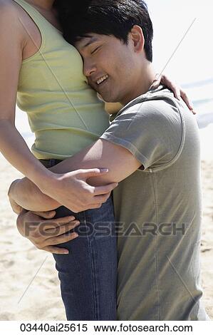 Man hugging woman View Large Photo Image Stock Photography - Man hugging woman. Fotosearch