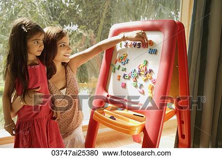 Stock Image - mother and daughter at easel. Fotosearch