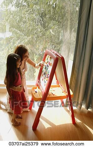 Stock Photo - mother and daughter at easel. Fotosearch