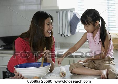 Mother and daughter baking together View Large Photo Image Stock Image - Mother and daughter baking together. Fotosearch