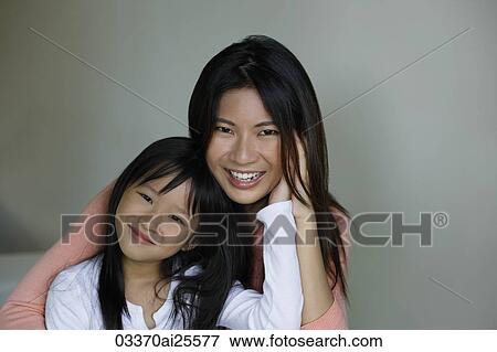 Mother and daughter embracing View Large Photo Image Stock Photo - Mother and daughter embracing. Fotosearch