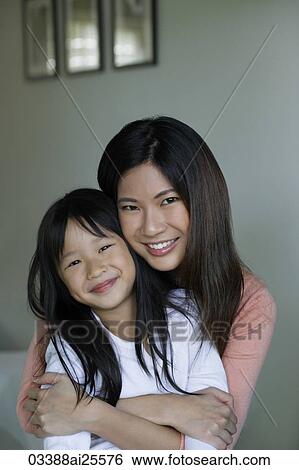 Stock Photograph - Mother and daughter embracing. Fotosearch