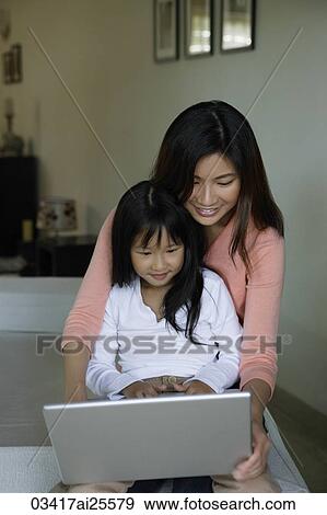 Mother and daughter working at laptop computer View Large Photo Image Stock Photo - Mother and daughter working at laptop computer. Fotosearch