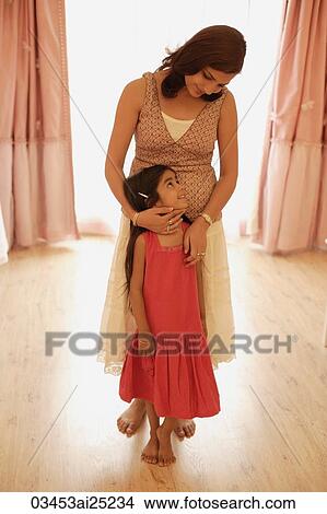 Picture - mother embracing daughter. Fotosearch