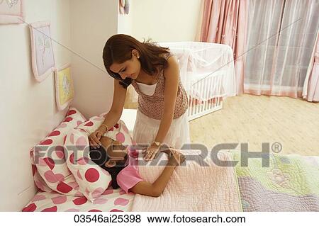 mother with hand on daughters forehead View Large Photo Image Stock Photo - mother with hand on daughters forehead. Fotosearch