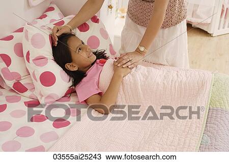 Stock Image - mother's hand on daughter's forehead. Fotosearch