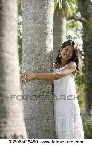 teen girl hugging tree in park View Large Photo Image Stock Image - teen girl hugging tree in park. Fotosearch