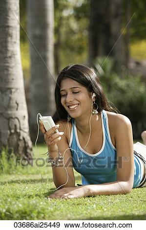 teen girl listening to music in park View Large Photo Image Stock Photo - teen girl listening to music in park. Fotosearch