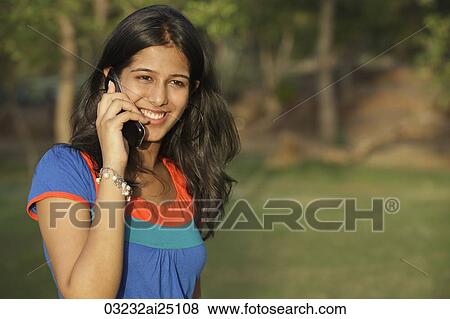 Teen girl on cell phone View Large Photo Image Stock Photo - Teen girl on cell phone. Fotosearch