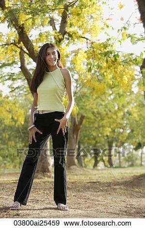 teen girl standing under blooming tree View Large Photo Image Stock Photo - teen girl standing under blooming tree. Fotosearch