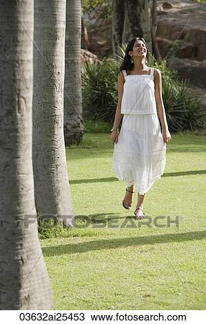 teen girl walking on grass in park View Large Photo Image Stock Image - teen girl walking on grass in park. Fotosearch