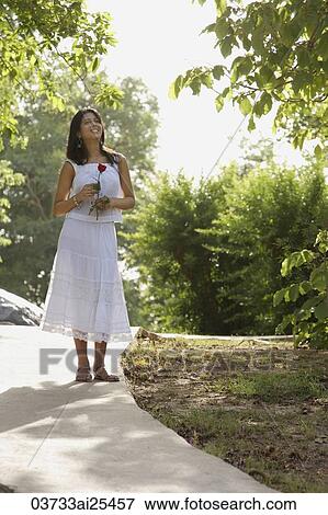 teen girl walking on path through park, with rose View Large Photo Image Stock Photo - teen girl walking on path through park, with rose. Fotosearch