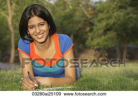 Teen girl writing in notebook, in park View Large Photo Image Stock Photo - Teen girl writing in notebook, in park. Fotosearch