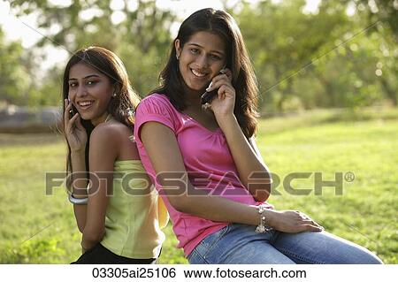 Teen girls on mobile phones View Large Photo Image Stock Photograph - Teen girls on mobile phones. Fotosearch
