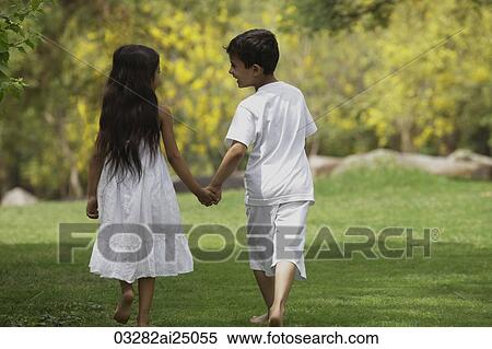 two children holding hands walking View Large Photo Image Stock Photography - two children holding hands walking. Fotosearch