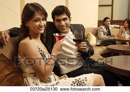 Stock Image - two couples in restaurant. Fotosearch