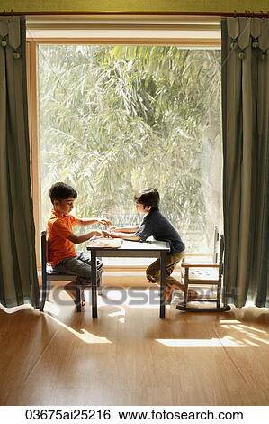 two little boys playing at table View Large Photo Image Stock Photograph - two little boys playing at table. Fotosearch