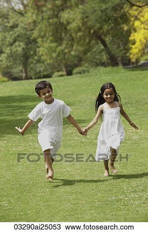 two little children running through a park holding hands View Large Photo Image Stock Image - two little children running through a park holding hands. Fotosearch