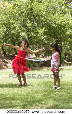 two little girls playing with hula hoop View Large Photo Image Stock Photography - two little girls playing with hula hoop. Fotosearch