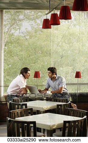 two men at laptop in cafe View Large Photo Image Stock Image - two men at laptop in cafe. Fotosearch