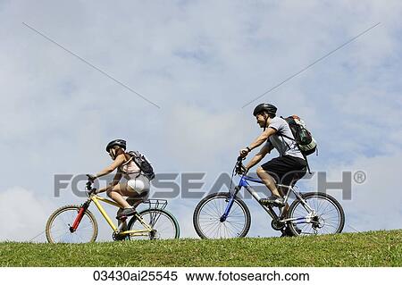 Stock Photography - Two people on bicycles. Fotosearch