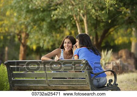 Two teen girls giggling in park View Large Photo Image Stock Image - Two teen girls giggling in park. Fotosearch